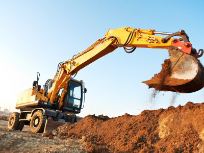 Excavator digging land for grading in Charlotte, NC.